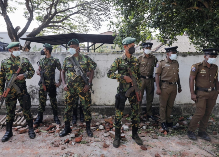 Sri Lankan Special Task Force and Police officers stand guard at the top of the road to Sri Lankan President Gotabaya Rajapaksa's residence, after police officers and demonstrators clashed at a protest against him, as many parts of the crisis-hit country faced up to 13 hours without electricity due to a shortage of foreign currency to import fuel, in Colombo, Sri Lanka April 1, 2022. REUTERS/Dinuka Liyanawatte